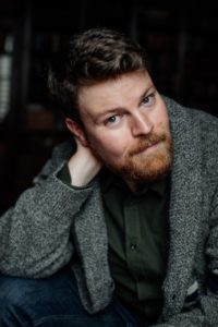 Photo of actor Chris Oglesby sitting